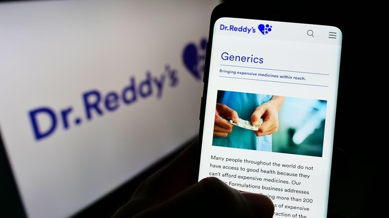 Person holding cellphone with web page of pharmaceutical company Dr. Reddy’s Laboratories Ltd on screen with logo