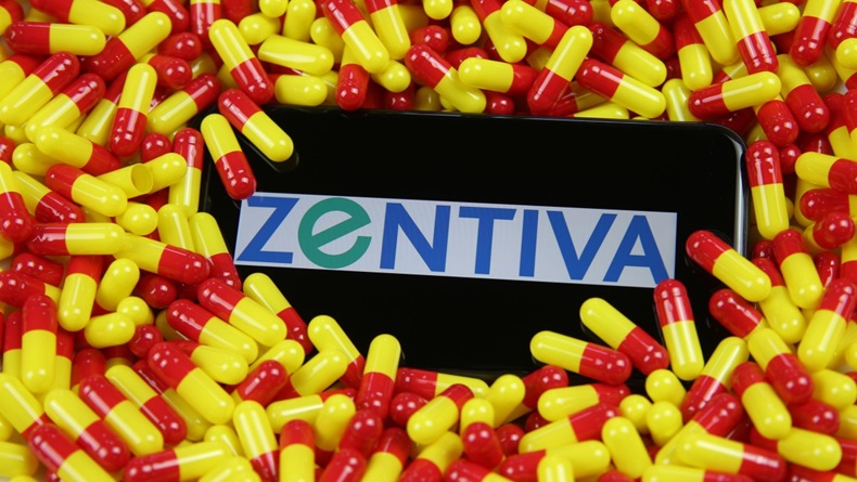 Phone screen with Zentiva logo on pile of drug capsules