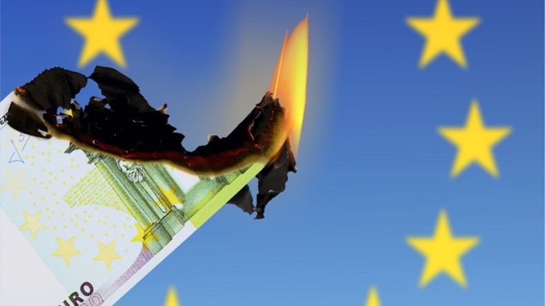 Euro on fire against backdrop of EU flag