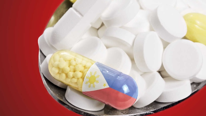 Pile of pills, with one pill bearing the flag of the Philippines 