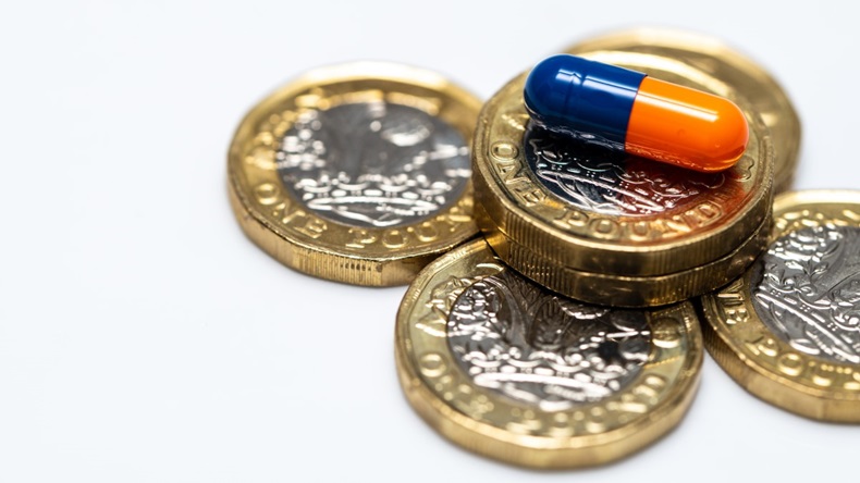 Blue and orange capsule on a pound coin