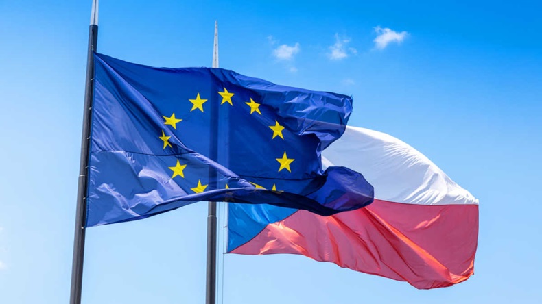 Photo of the EU and the Czech flags flying side by side against a blue sky