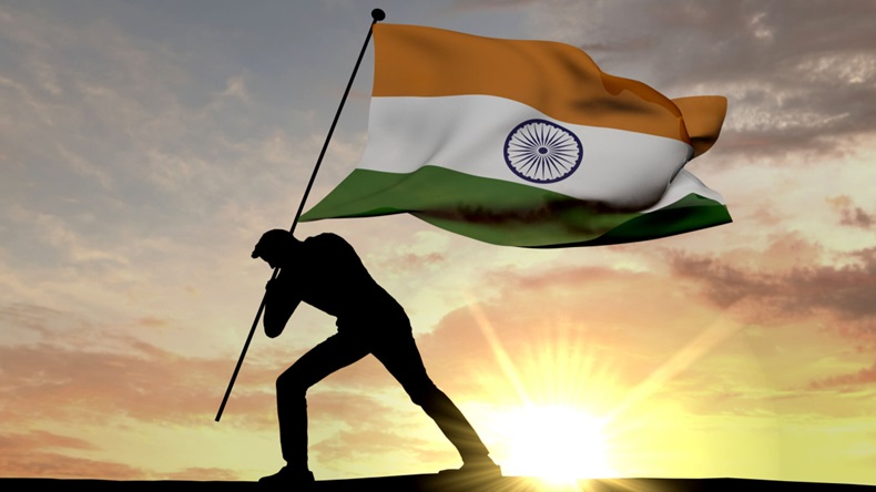 India flag being pushed into the ground by a male silhouette