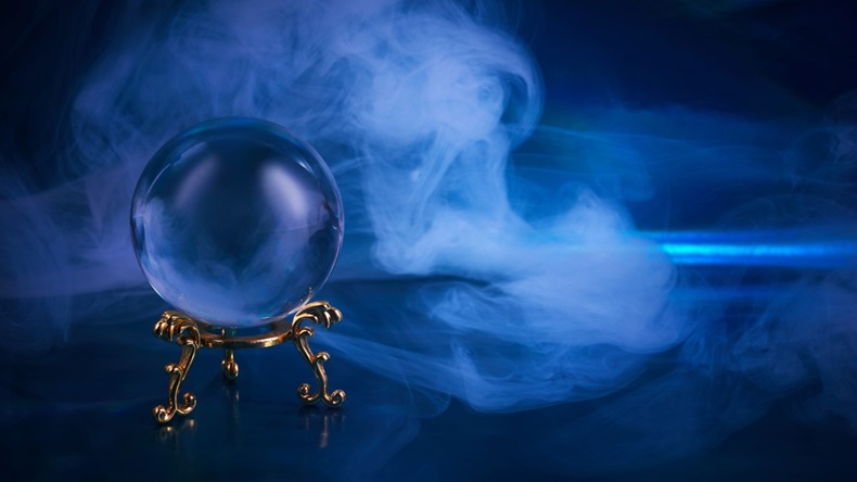 Crystal ball with blue smoke, uncertainty concept