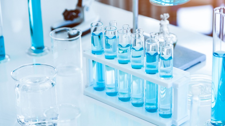 Laboratory test tubes and solution with stethoscope background