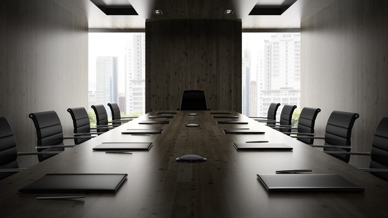 Boardroom with desk and empty chairs
