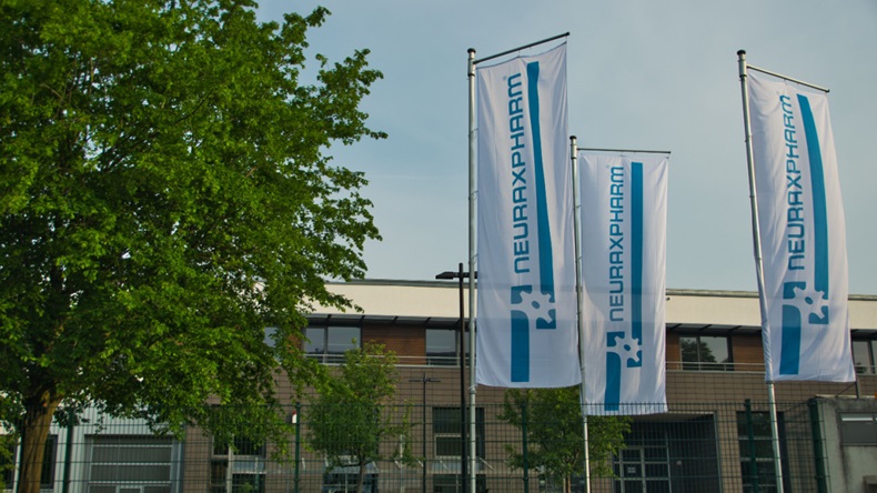 Flags at main entrance of Neuraxpharm company building