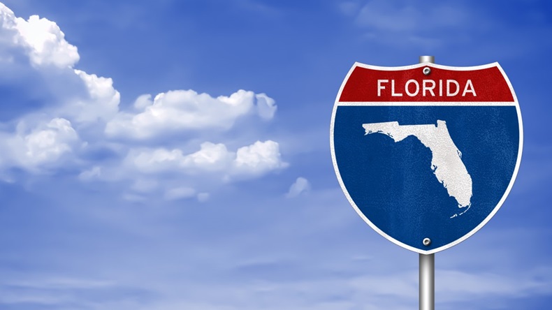 Florida state sign in front of blue sky and cloud