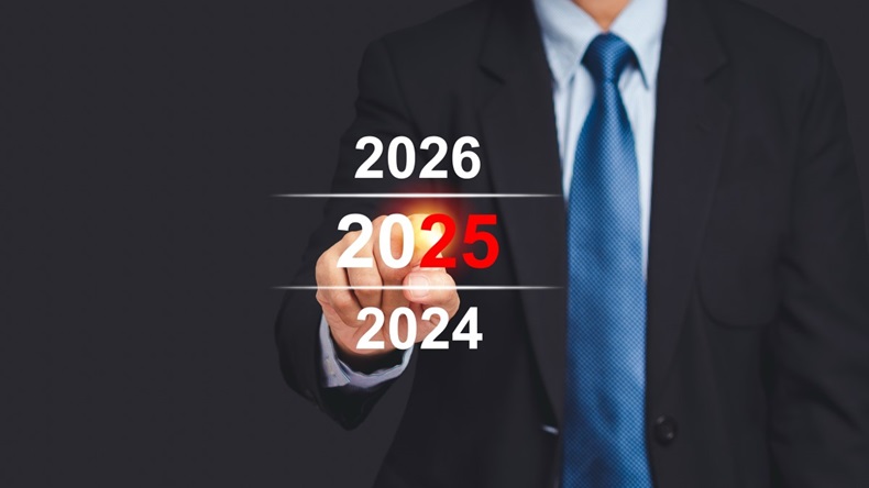 Man in suit and tie points to year 2025