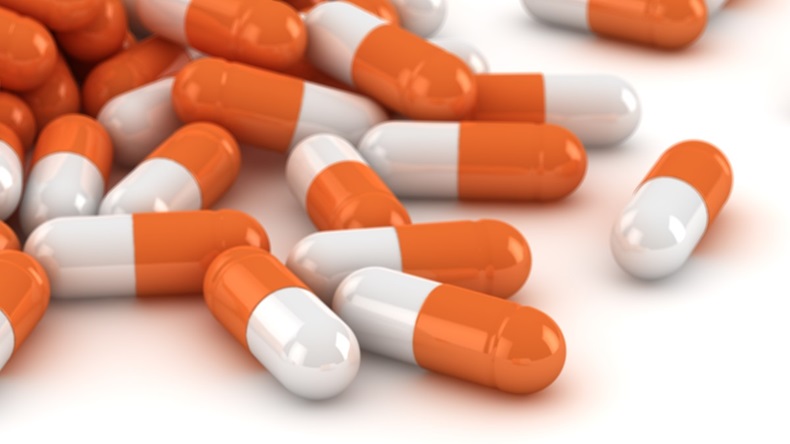 Pile of orange and white capsules