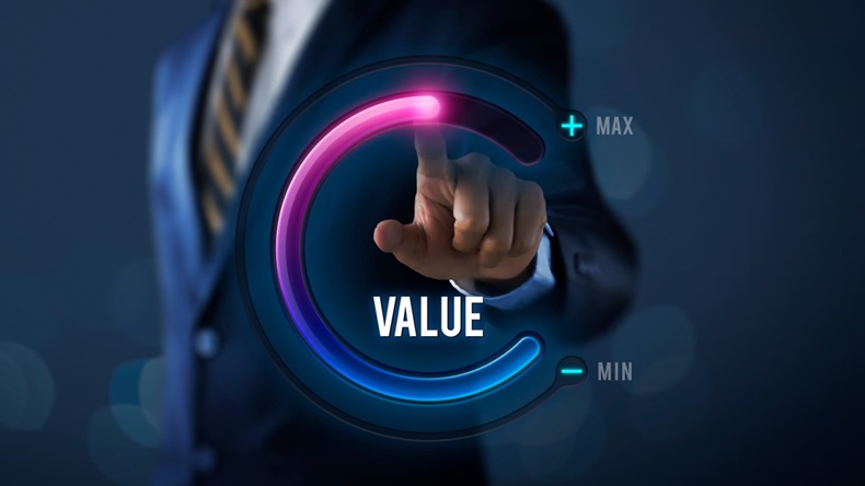 Businessman turning value dial up to maximum