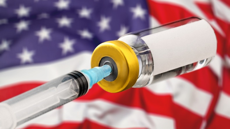 Syringe in vial in front of US flag