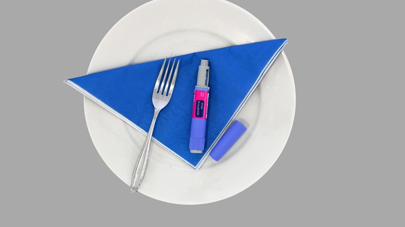 Semaglutide pen on a white plate with a blue napkin