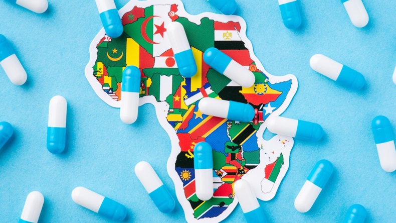 Pills and capsules over a map of Africa continent with national flags of countries