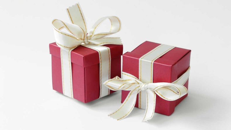 Two gifts with bright ribbons on a neutral background
